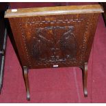 An early 20th century relief carved oak fire screen the panel depicting opposing winged griffins,