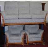 A contemporary beech framed and floral upholstered three-piece suite comprising; three-seater sofa