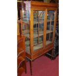 A circa 1900 mahogany and satinwood crossbanded double door glazed china display cabinet, having