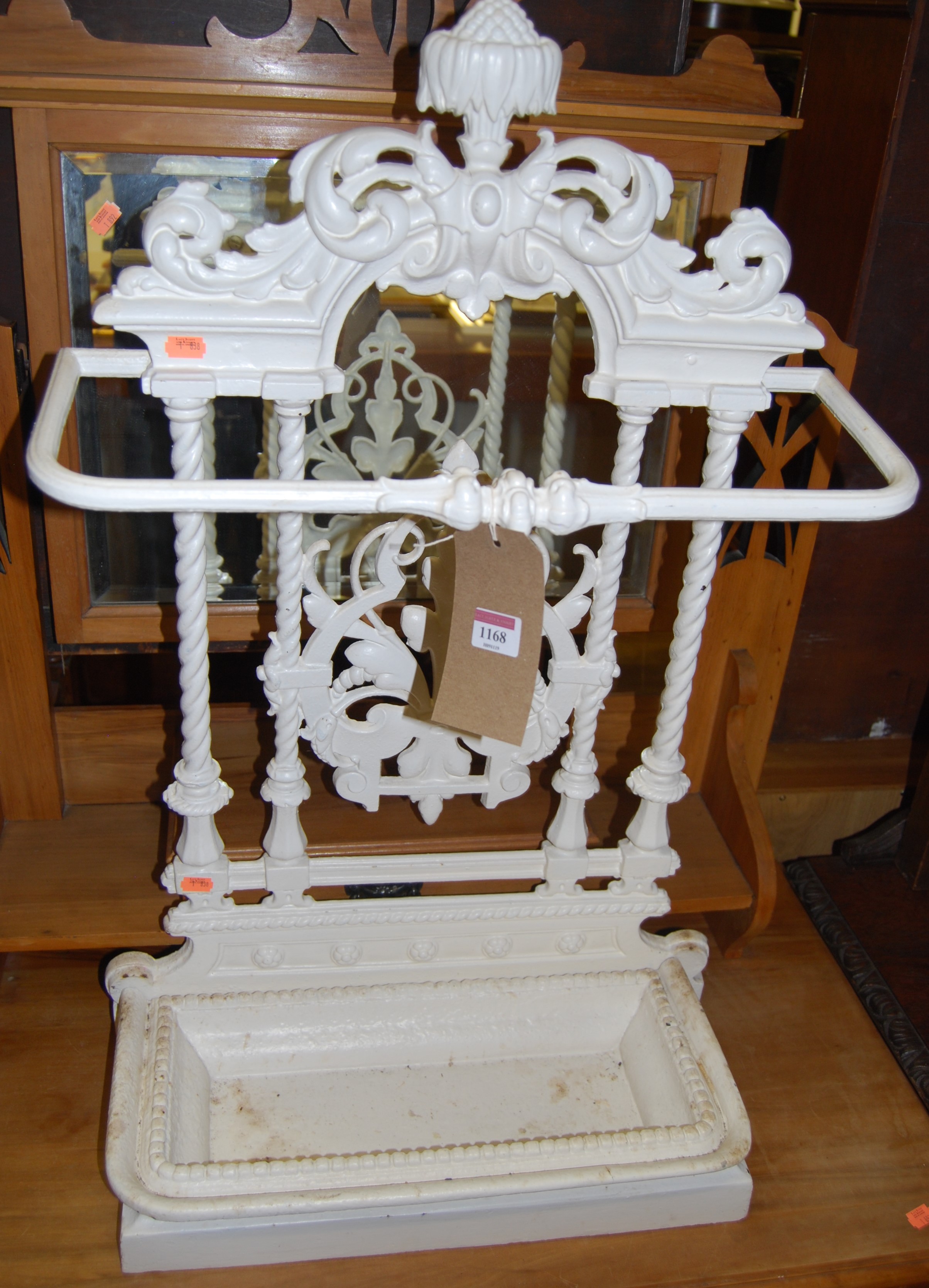 A Victorian cast iron and later white painted stick stand, having typical pierced floral