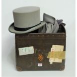 An early 20th century grey felt top-hat, bearing a label for Moss Brothers, Covent Garden,