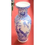 A large blue and white floor vase, in the Chinese style, of baluster form, decorated with birds