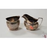 A 19th century silver cream jug, of helmet shape, having angular handle and bright cut decoration;