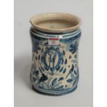 A 19th century earthenware jar, of waisted cylindrical form, underglaze blue and white decorated