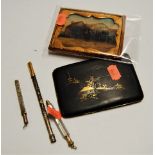 A Komai style Japanese pocket cigarette case, inlaid with yellow and white metal mountain scene;