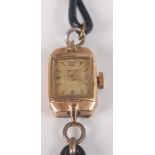 A yellow metal Smiths manual wind wristwatch, with champagne rectangular quarter Arabic dial and