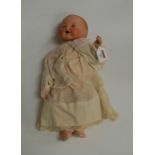 An Armand Marseille bisque head doll, having fixed blue eyes, open mouth, and bent limbed