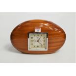 A 1950s Smiths walnut cased mantel clock, having a square dial with Arabic numerals and alarm