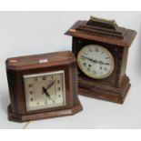 A late 19th century continental oak cased mantel clock, having a circular enamelled dial with