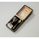 A sterling silver egg cup with spoon, in fitted leather case