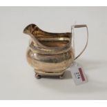 A 19th century silver cream jug, of squat bellied form, having angular handle and floral bright