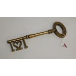 A large decorative brass key, 34cm