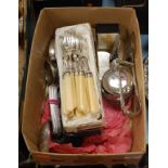 A box of miscellaneous silver plated wares, to include pair of asparagus tongs, loose fish cutlery