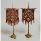 A pair of 19th century gilt brass table screens, each shield shaped panel with Berlin beadwork
