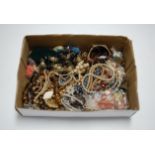 A box of miscellaneous costume jewellery to include faux pearl necklace etc