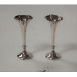 A pair of Edwardian silver trumpet shape spill vases, on loaded bases, h.12cm