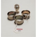 Three various silver napkin rings; together with a pedestal pepperette (4)