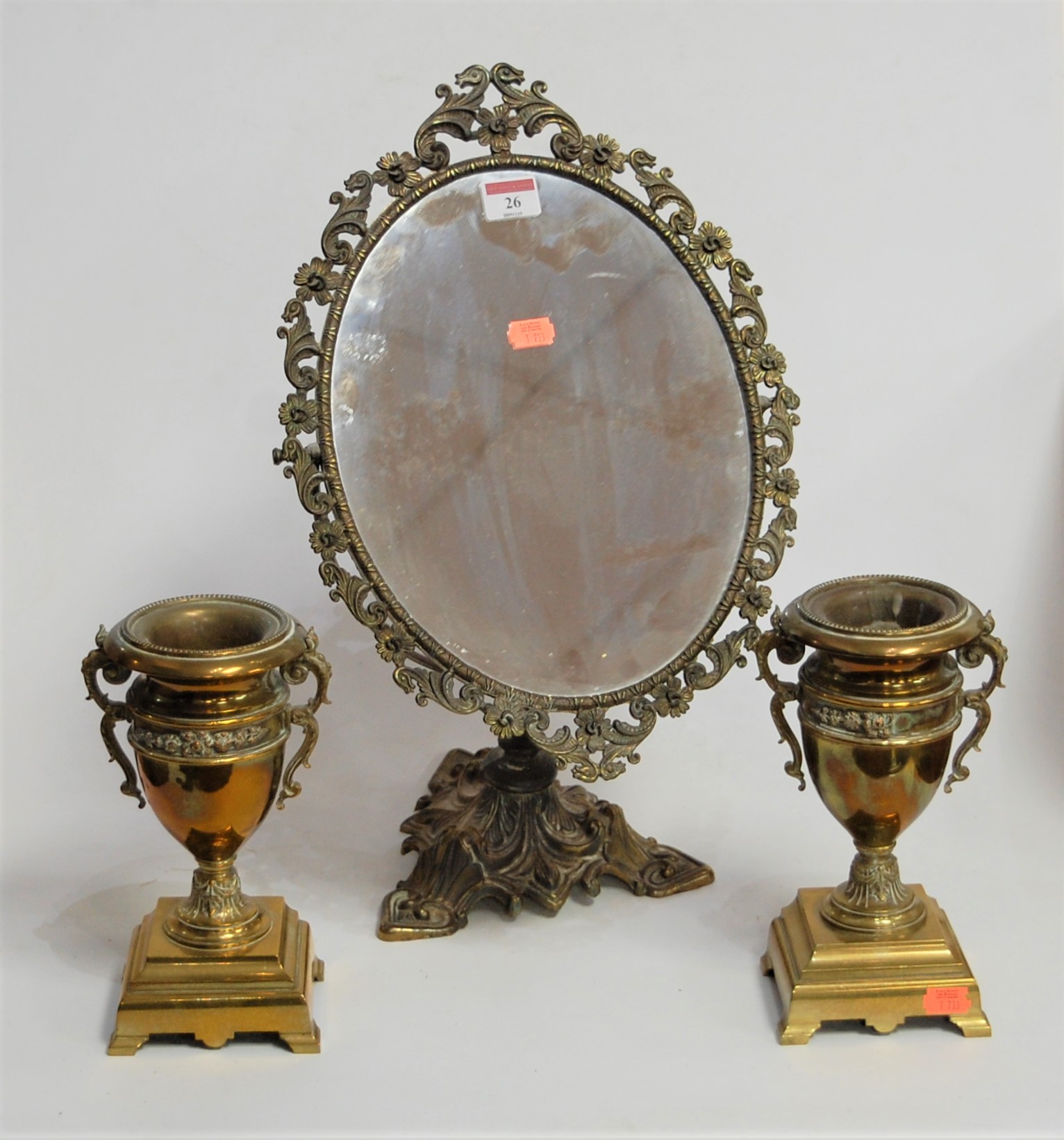 A pair of early 20th century brass garniture urns, each having twin handles with a band of