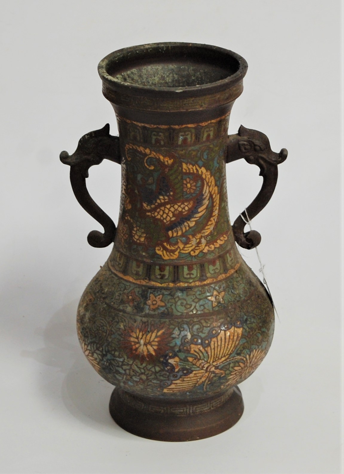 A 19th century cloisonné vase, having slender neck to a bulbous lower body, twin iron elephant