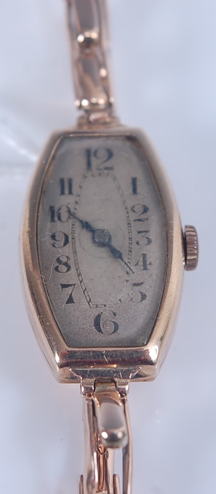 A 9ct yellow gold manual wind wristwatch, with sprung metal bracelet and oval discoloured Arabic