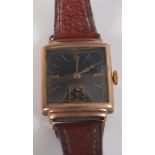 A 9ct yellow gold manual wind 'non-magnetic' wristwatch, with square black baton dial and brown