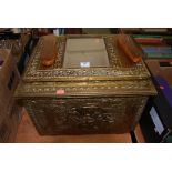 A brass coal bin relief decorated with figures together with a similar brass framed wall mirror