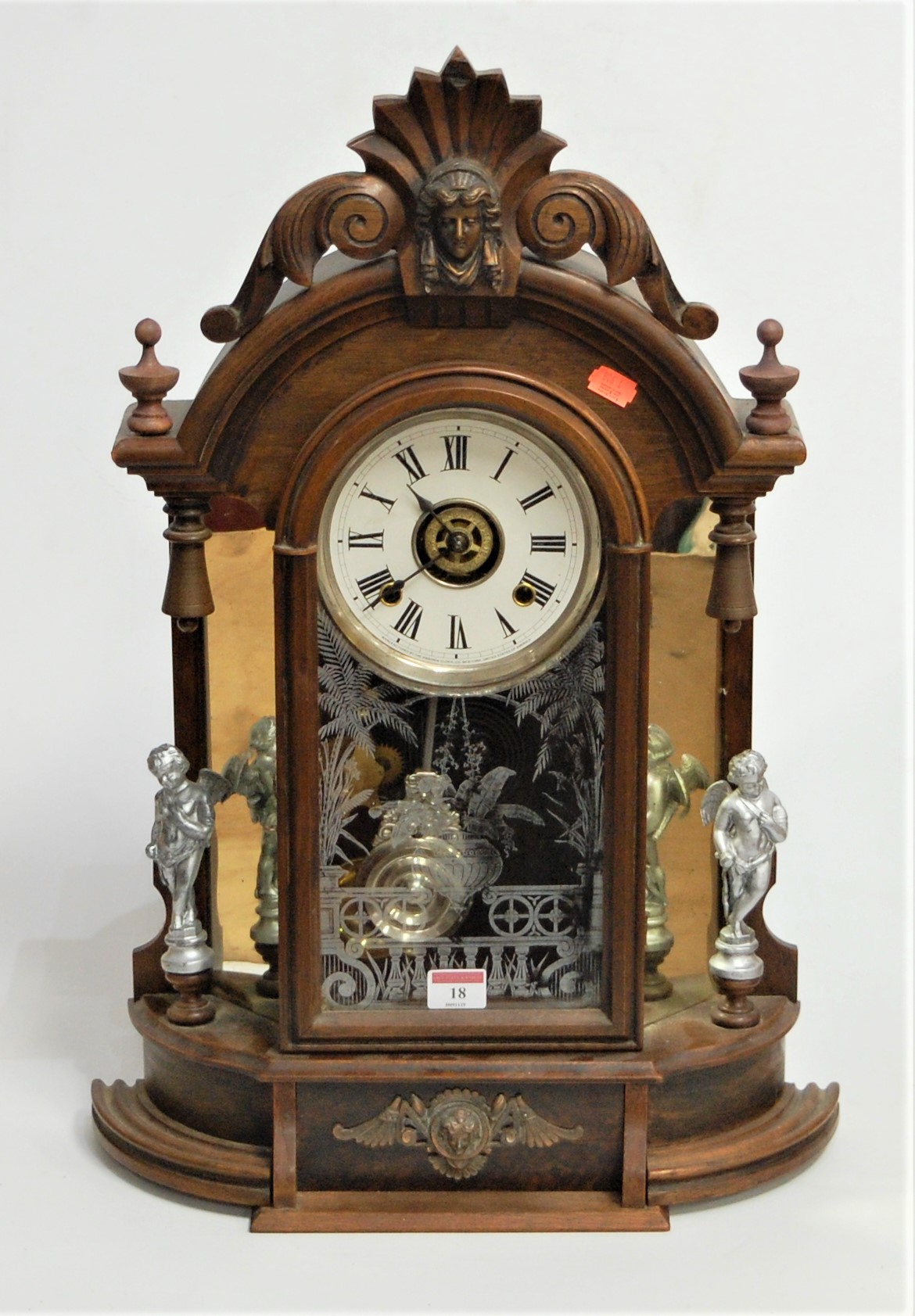 A late 19th century walnut cased mantel clock, the paper dial with Roman numerals, having eight