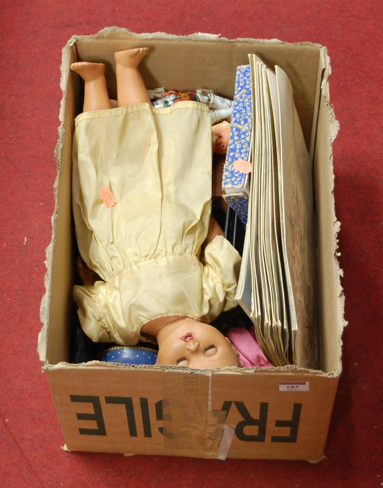 A box of miscellaneous items to include a celluloid doll, Black Forest style bear, egg cups etc