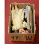 A box of miscellaneous items to include a celluloid doll, Black Forest style bear, egg cups etc