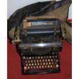 An American Underwood typewriter, with tin case