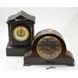 A late Victorian black slate and marble cased mantel clock of architectural form having enamelled