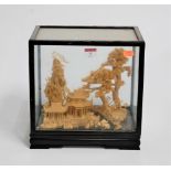 An early 20th century Chinese cork diorama, carved with pagodas within landscape, case w.28cm, d.