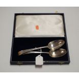A pair of George IV silver serving spoons, maker John Lamb, London 1823, in associated blue