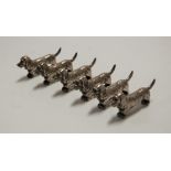 A set of six silver plated knife rests, each in the form of a dachshund, length 6.5cm