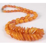 An amber necklace, arranged as slice cut sections and small barrel beads, gross weight 22g, length