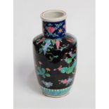 A Chinese stoneware vase, of baluster form, on a black ground enamel decorated with flowers, h.31cm