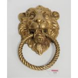 A large cast brass doorknocker in the form of a lion's head in the Victorian style, length 36cm