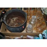 A cast iron cauldron together with a pair of cut glass decanters and various drinking glasses