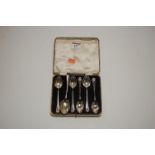 A set of five George V silver teaspoons, each with shell cast terminal; together with one odd