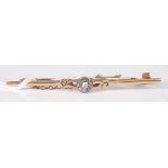 An 18ct yellow gold bar brooch, having a nine stone old cut diamond circular cluster to the