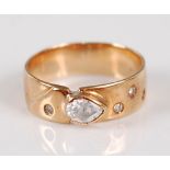 A 14ct gold diamond dress ring, arranged as a raised pear cut diamond, weighting approx 0.25 carats,
