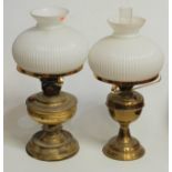 An early 20th century brass oil lamp, having opalescent glass shade and Duplex burner, h.50cm;