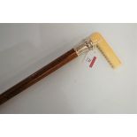 A Victorian walking cane, having a mallacca shaft stamped L Holmes, the white metal collar with