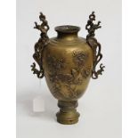 A Japanese bronze twin handled vase, of baluster form, relief decorated to each side with bird of