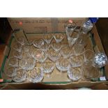 A collection of various etched and cut glass drinking glasses and decanters