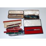 A collection of fountain pens, to include a cased Burnham blue pearloid fountain pen, Parker etc