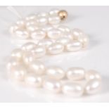 A single row necklace of 35 baroque freshwater pearls, strung knotted to a 14ct yellow gold ribbed