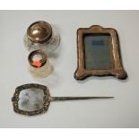 An Edwardian silver clad easel photograph frame, h.19cm; together with two silver topped glass