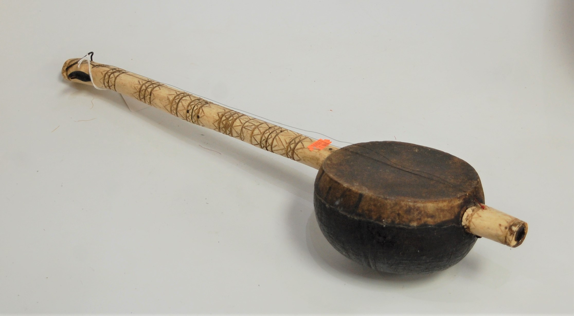 A carved bone coconut and hide covered erhu, length 56cm