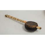 A carved bone coconut and hide covered erhu, length 56cm